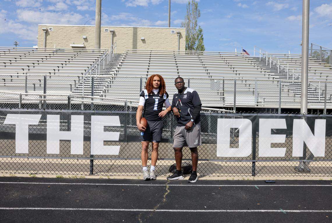 Hough High School varsity football quarterback Ethan Royal, left, and head football coach DeShawn Baker at the school football stadium on Tuesday, April 14, 2026
