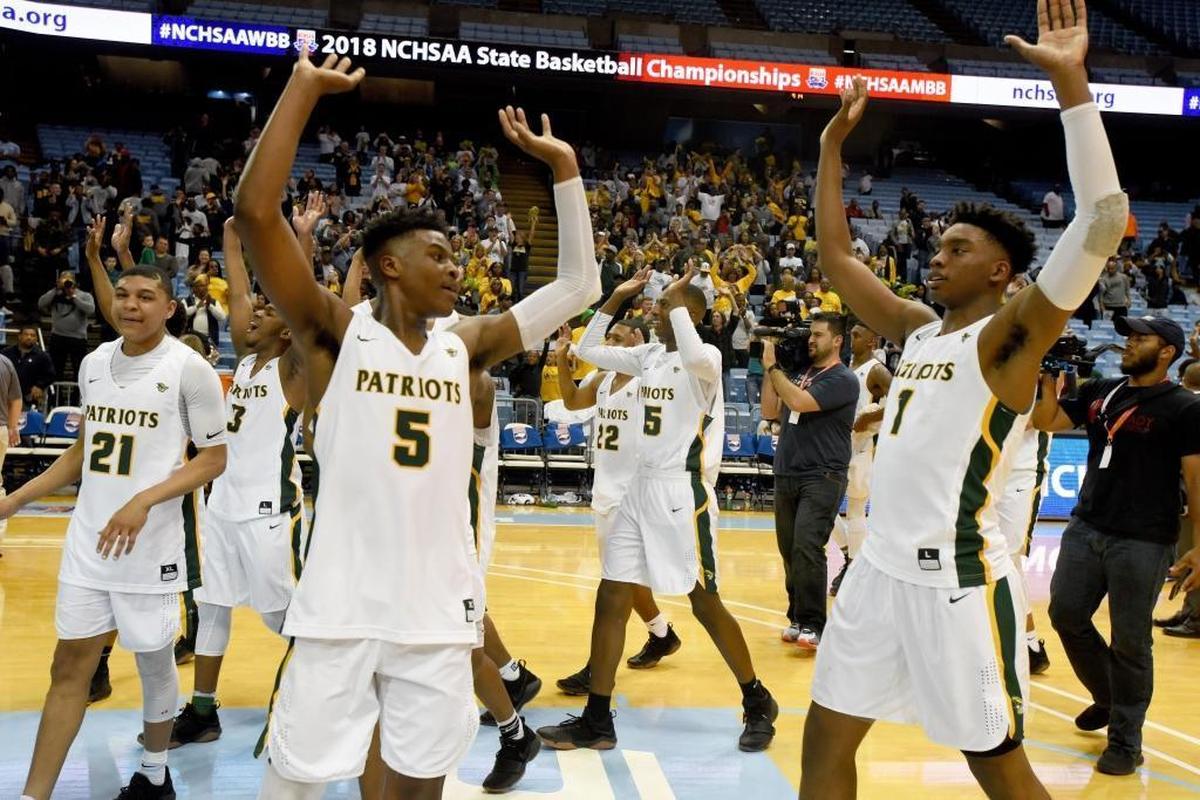Independence players celebrate winning the state 4A boys’ basketball championship over Wake Forest Heritage at the Smith Center in Chapel Hill.