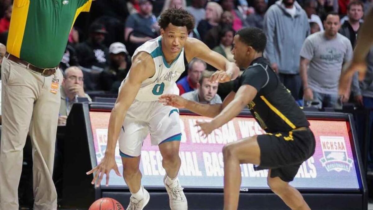 Cox Mill's Wendell Moore (0) drives the baseline during in the first quarter against Greensboro Smith.