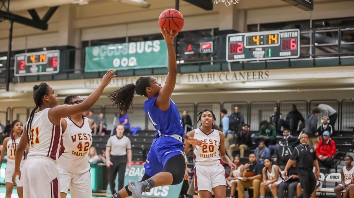 Carmel Christian's Christiana McLean (Center) drives to the basket for two points during early first half action. BSN Queen City Clash Women's Final December 23, 2017.