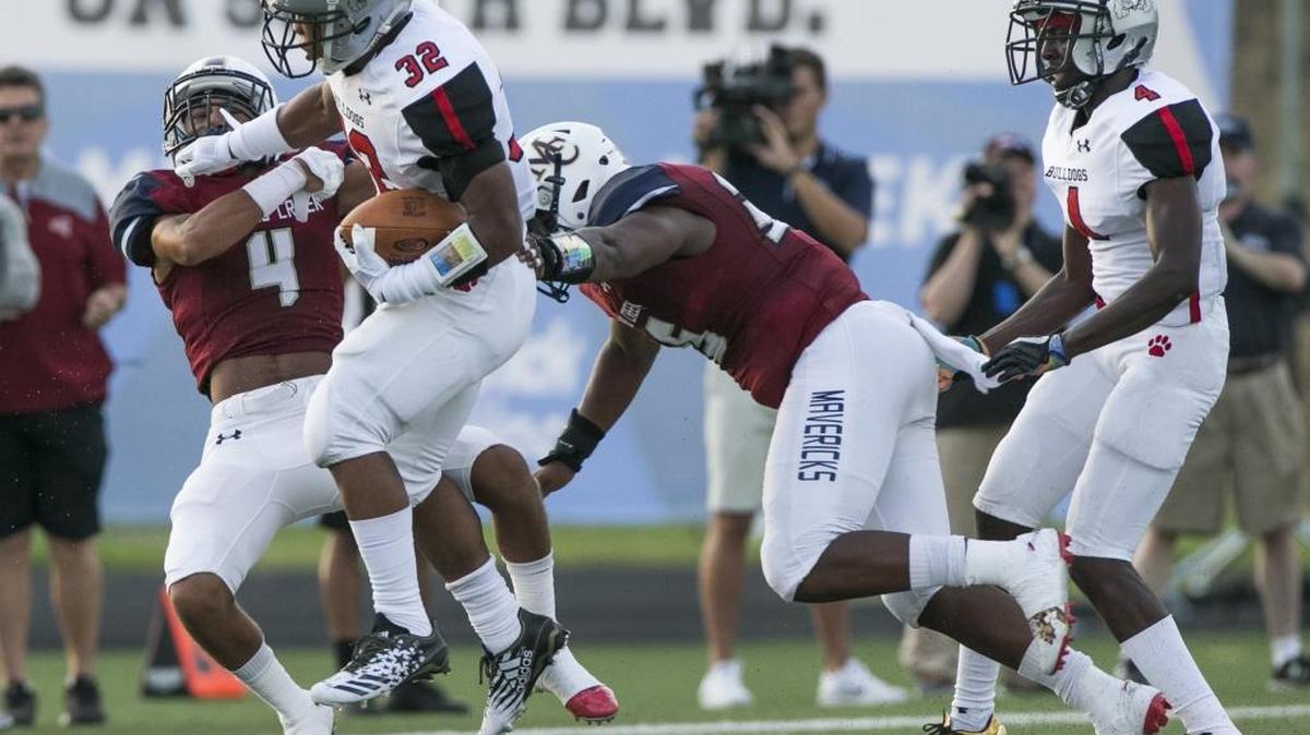 Butler's Nijere Peoples (32) tries to evade the Mallard Creek defense during a varsity football game at Mallard Creek High School Friday, August 25, 2017 in Charlotte, NC. Photo by JASON E. MICZEK - Special to the Observer