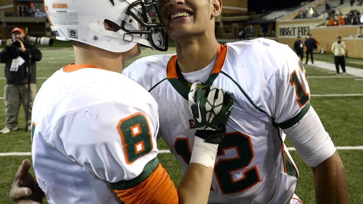 East Lincoln Mustangs QB Chazz Surratt (right), seen with wide receiver Nick Quigley (8) at the 2014 NCHSAA 2AA State Championship game, was named N.C. Gatorade player of the year Thursday.