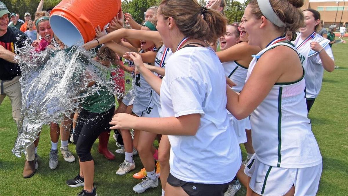 Charlotte Country Day girls lacrosse coach Kristy Boyles gets doused with ice water by her players following the Buccaneers’ 18-2 victory over Durham Academy in the NCISAA state championship game, held Saturday, May 21, 2016, at Country Day’s Belk Stadium. It was the Buccaneers’ fourth straight state title. CREDIT: Bill Kiser