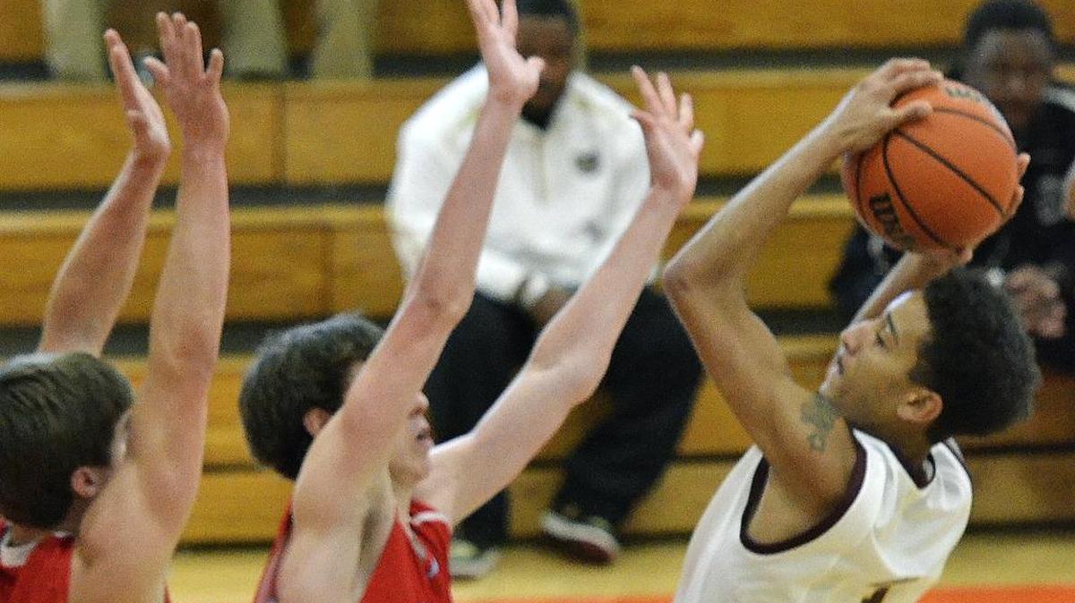 Charlotte Catholic defenders converge on West Charlotte senior guard #3 Mark Alexander in the first half Saturday. Charlotte Catholic defeated West Charlotte 66-46 during the first game on Saturday Dec. 5, 2015 at the Southeast National Hoops Festival at Vance High School.