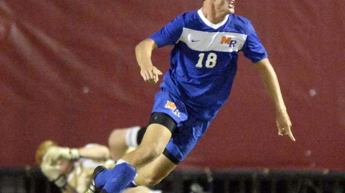 
Marvin Ridge's Frederick Bailey (18) celebrates his goal past Charlotte Catholic goalkeeper Austin Schwartz, rear, on Tuesday, September 1, 2015. Marvin Ridge won, 1-0. 
