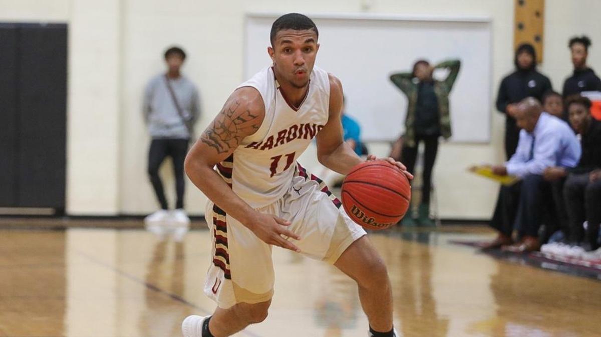 Harding’s Quinten Thomas drives to the basket against Olympic in a battle of first-place SoMeck teams. Olympic won in a blowout.