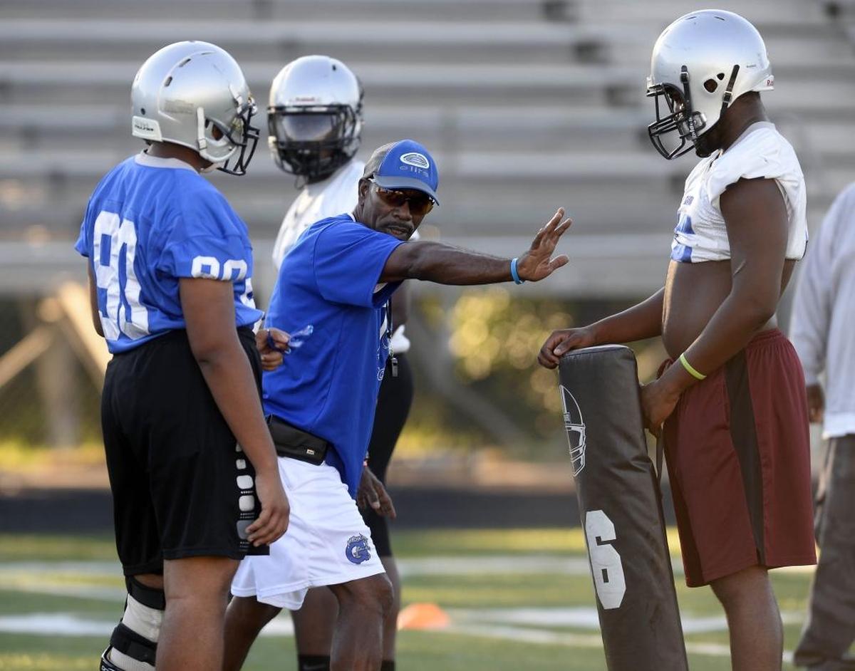 New Garinger football coach Jeff Caldwell directs players during a drill Monday afternoon at the school.