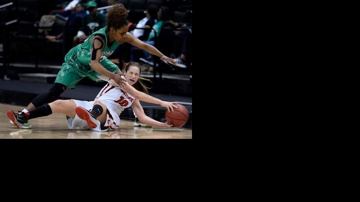 
Myers Park’s Aliyah Mazyck (23) continues to apply defensive pressure on Northwest Guilford’s Hayley Barber (10) as she falls to the floor in Winston-Salem during Saturday’s game. 
