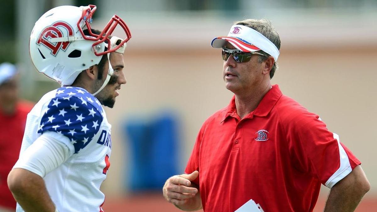 
Davidson Day coach Chad Grier (right), shown coaching son Will during the 2013 football season. 

