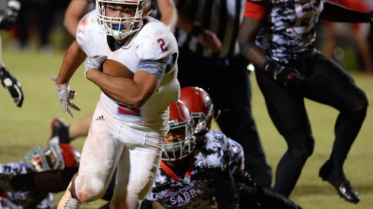 
Charlotte Catholic's Jaret Anderson fights free of the South Meck Sabres defense on a touchdown run during fourth-quarter action on Friday at South Meck. Charlotte Catholic defeated South Meck 10-7.

