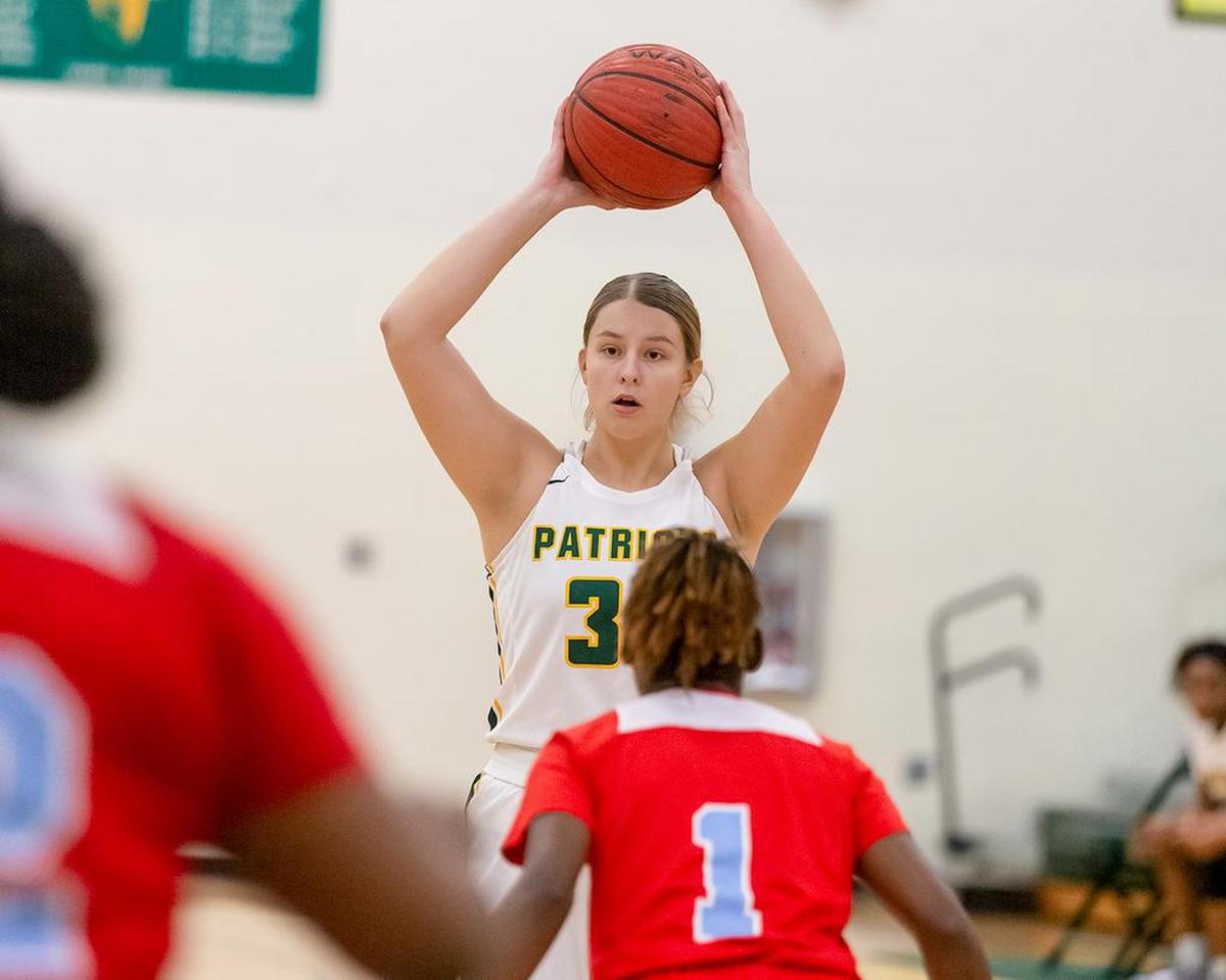 An Independence player looks for a teammate against Olympic Tuesda.
