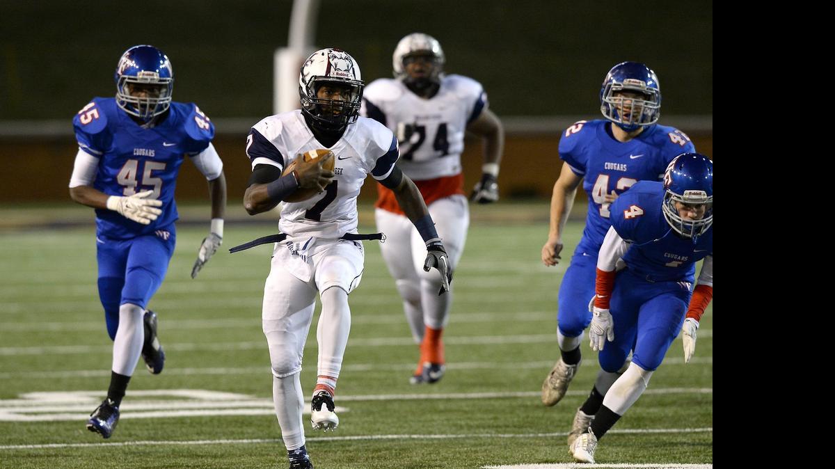 
Mallard Creek Mavericks quarterback James Smith (7) seen running against Wake Forest in the 2014 N.C. 4AA state final, will lead the Mavericks in a season-opening doubleheader at Memorial Stadium Aug. 22. Mallard Creek will play Independence; Myers Park will play Charlotte Country Day
