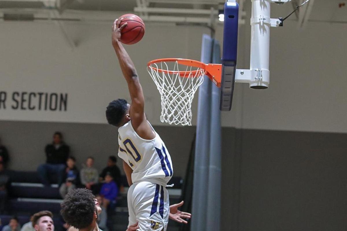 Donovon Gregory (10) of Carmel Christian completes the dunk.