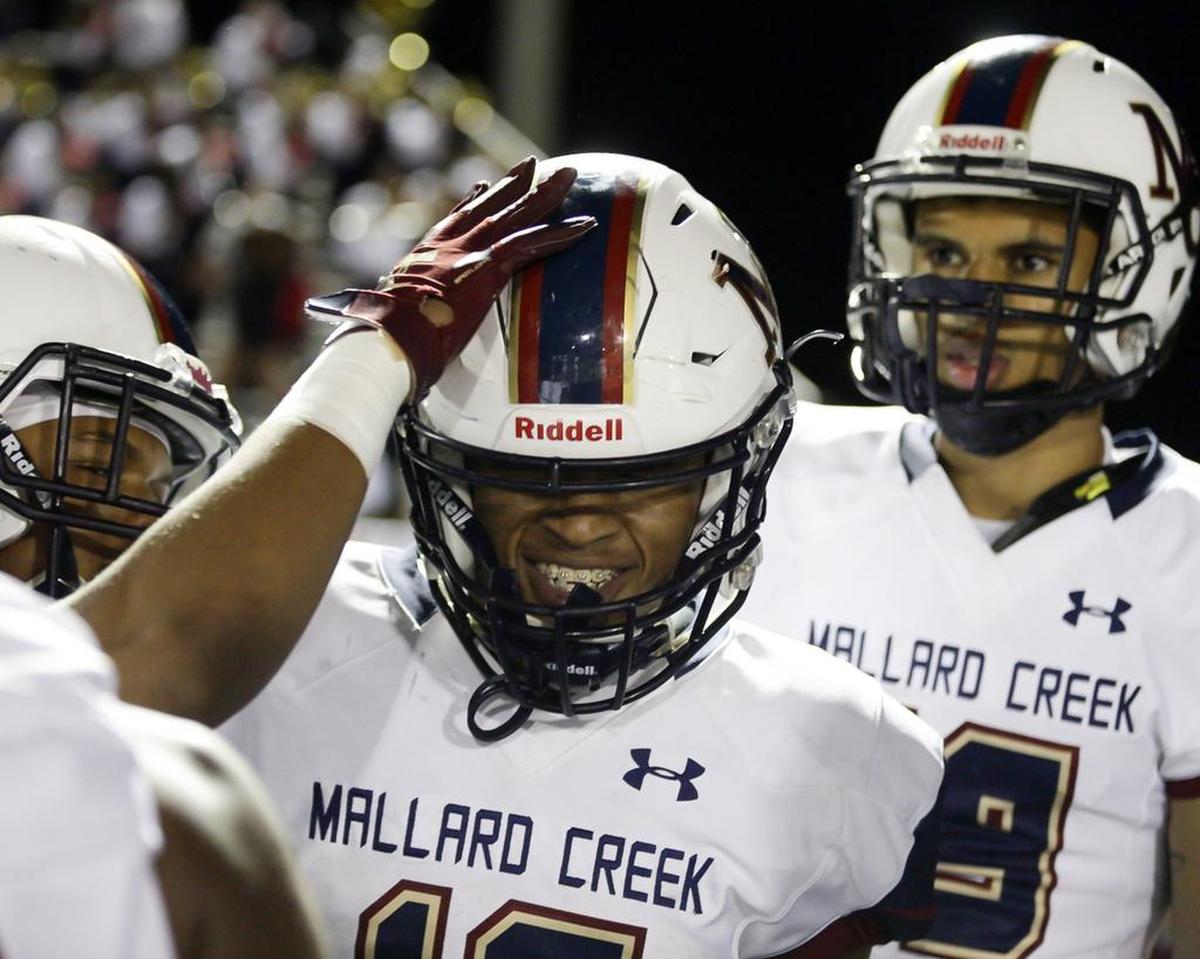 Mallard Creek’s Charles Mincey Jr. (12) celebrates his 75-yard touchdown run at Hough.