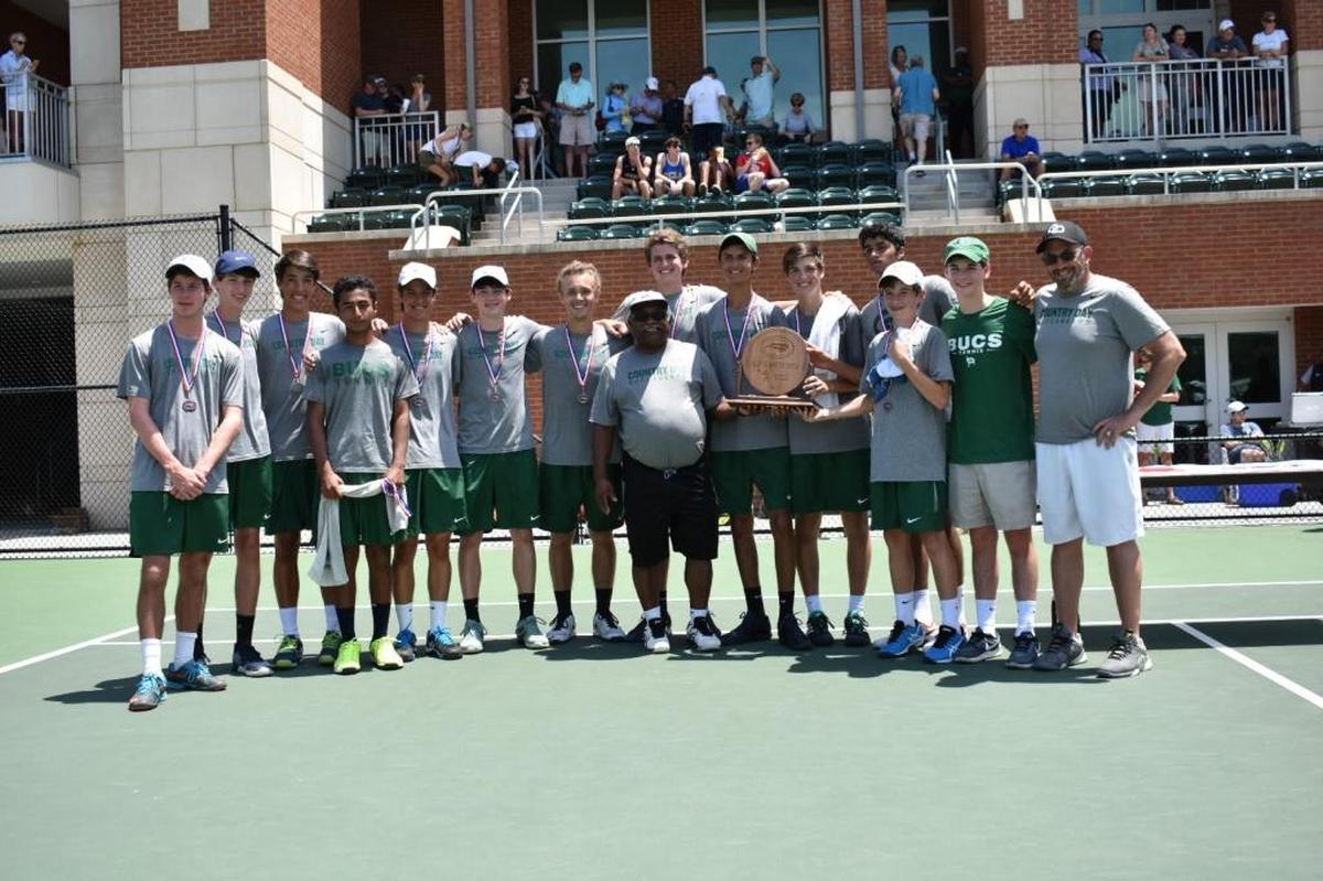 Charlotte Country Day’s state championship boys tennis team and coach Calvin Davis center