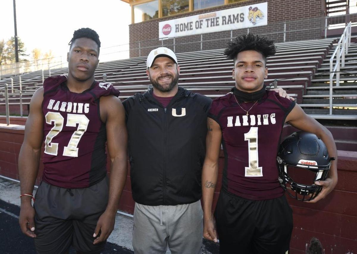 Harding High running back Quavaris Crouch, left, football coach Sam Greiner and quarterback Braheam Murphy pose for a picture on Thursday. The 10-1 Rams are a favorite to win the N.C. 4A football championship.