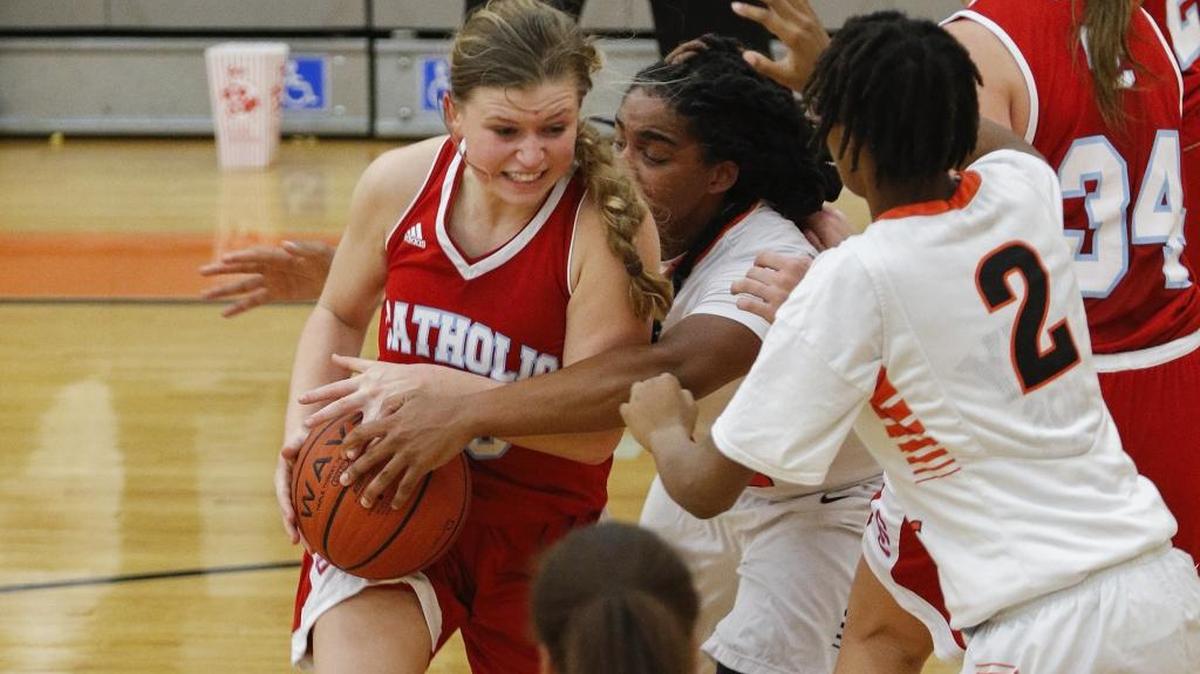 Charlotte Catholic guard Carson Dymock, left, fights to keep control of the basketball against Rocky River's Kanijah Cooper, center and Khamara Patterson during a high school basketball game in Mint Hill, N.C., Tuesday, Dec. 20, 2016. (Nell Redmond photo)