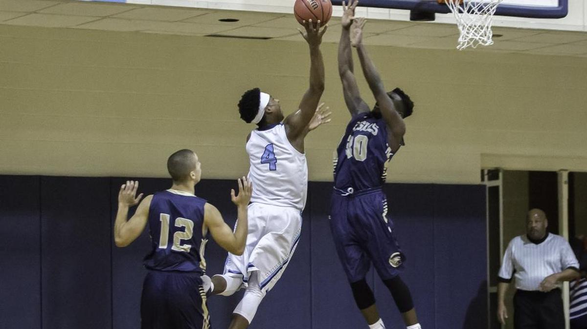 Nate Hinton takes the ball strong down the baseline over Concord First Assembly’s Amara Morris during first half action