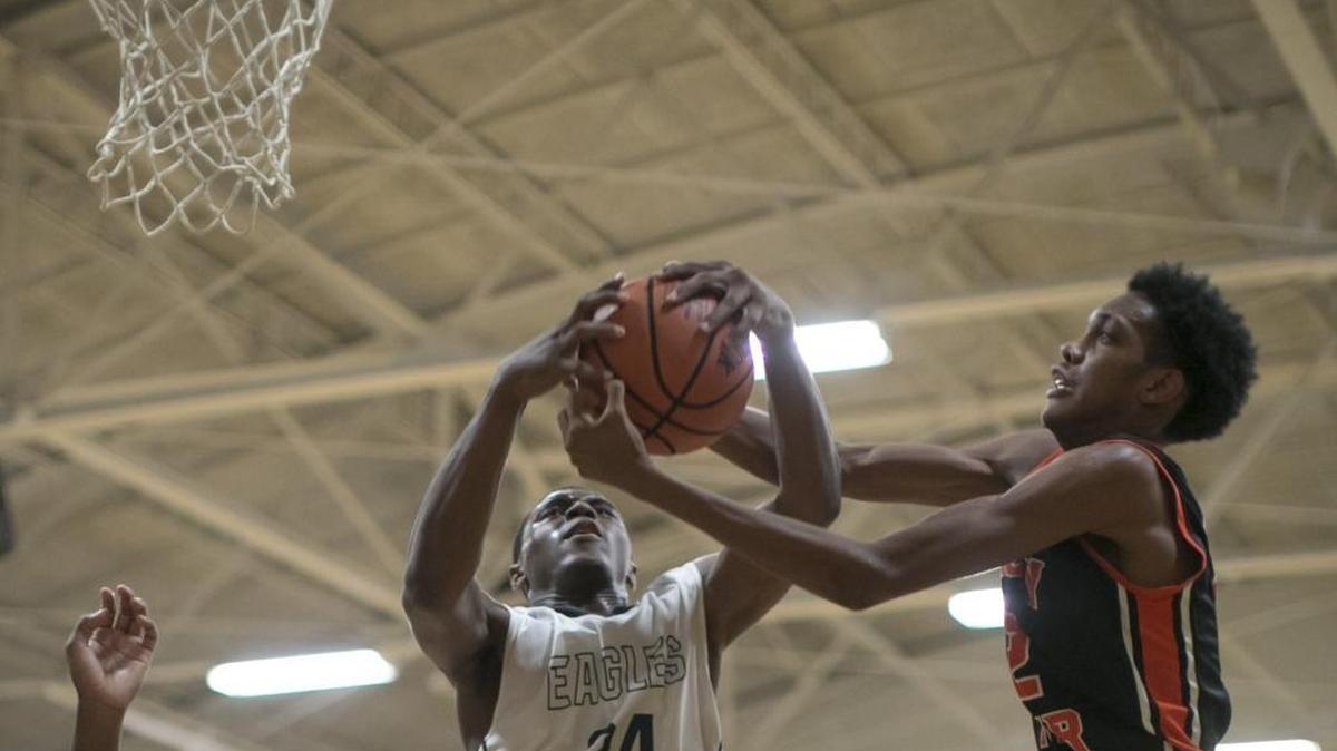 East Meck's Seth Bradbury (24) battles Rocky River's Keyon Wesley for the basketball during a prep basketball game Tuesday, December 15, 2015 at East Meck High School. JASON E. MICZEK - Special to the Observer