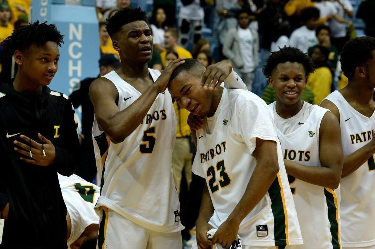 Independence players celebrate winning the state championship over Heritage after Saturday evening's NCHSAA state basketball championship 4A game between Independence and Wake Forest Heritage at the Smith Center in Chapel Hill.