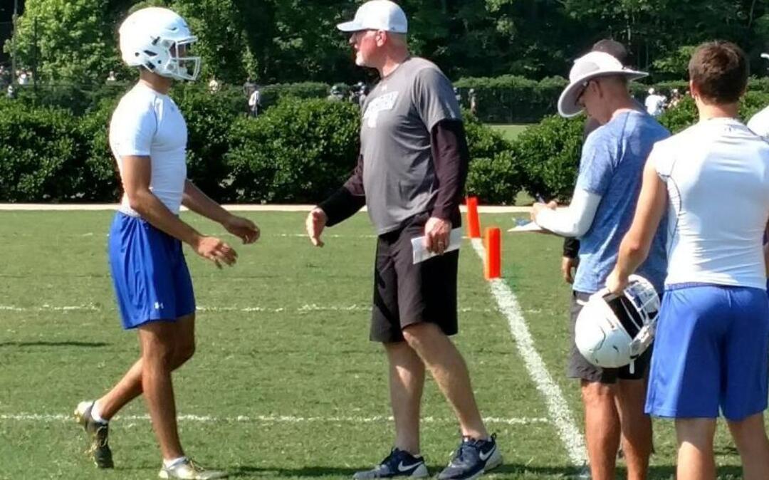 Charlotte Christian quarterback Garrett Shrader is greeted by offensive coordinator Pete Metzelaars after throwing a touchdown in the Carolina Panthers 7-on-7 Regional Championships on Thursday. Shrader is the top quarterback prospect from North Carolina in the Class of 2019.