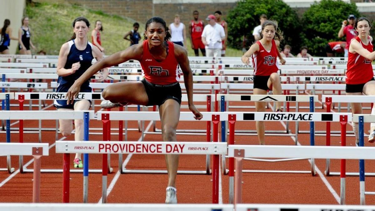 Providence Day’s Anna Cockrell clears a hurdle in a recent meet