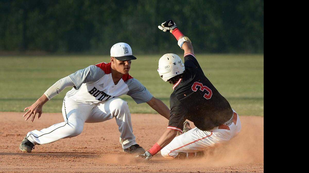 
From left, Butler's infielder Kobe Phillips tags Greensboro Page's runner Kevin Westlake out at second base during the third round NCHSAA4A playoff game played at Butler High School on May 19,2015.
