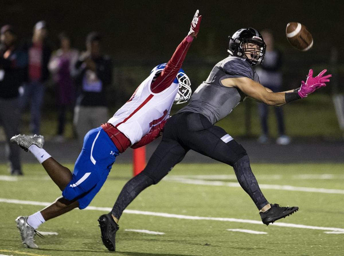 North Meck’s William Watts, left, stops Hough receiver Nolan Groulx from making a touchdown catch in the end zone.