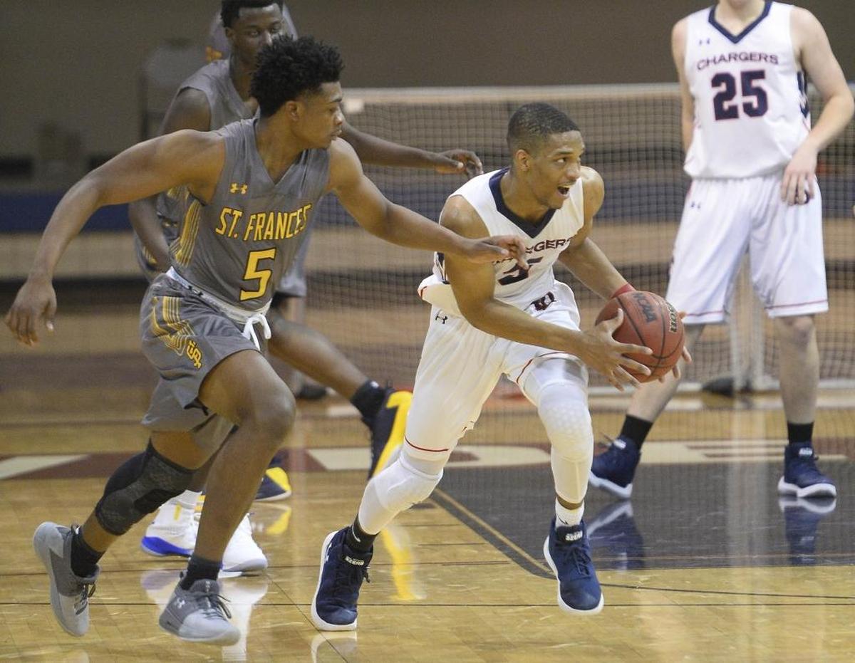 Providence Day's Isaac Suffren (5) steals the ball as St. Frances' Edward Fergunson (5) defends during their game in the 2017 Hoodie's House High School Hoops Classic on Thursday, December 28, 2017.