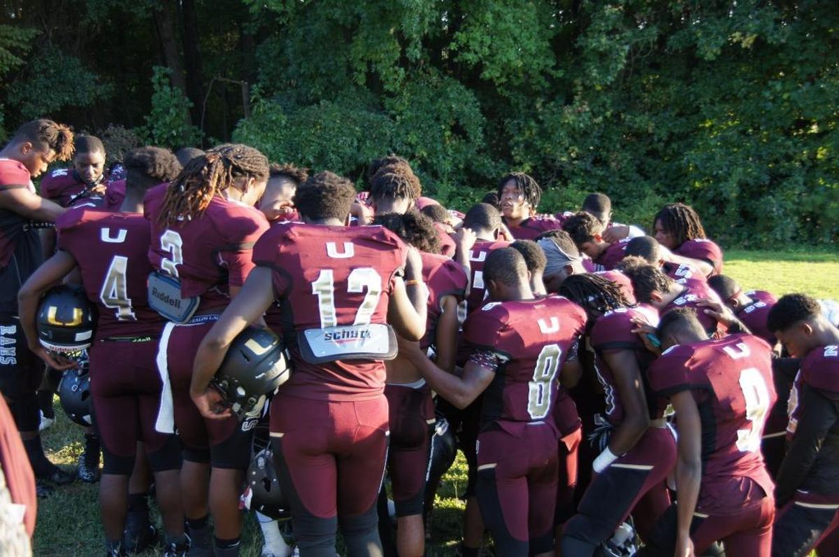 Before every game, the Harding High football team comes together in prayer. The team’s motto is “Make Him stand up,” with the H being capitalized.