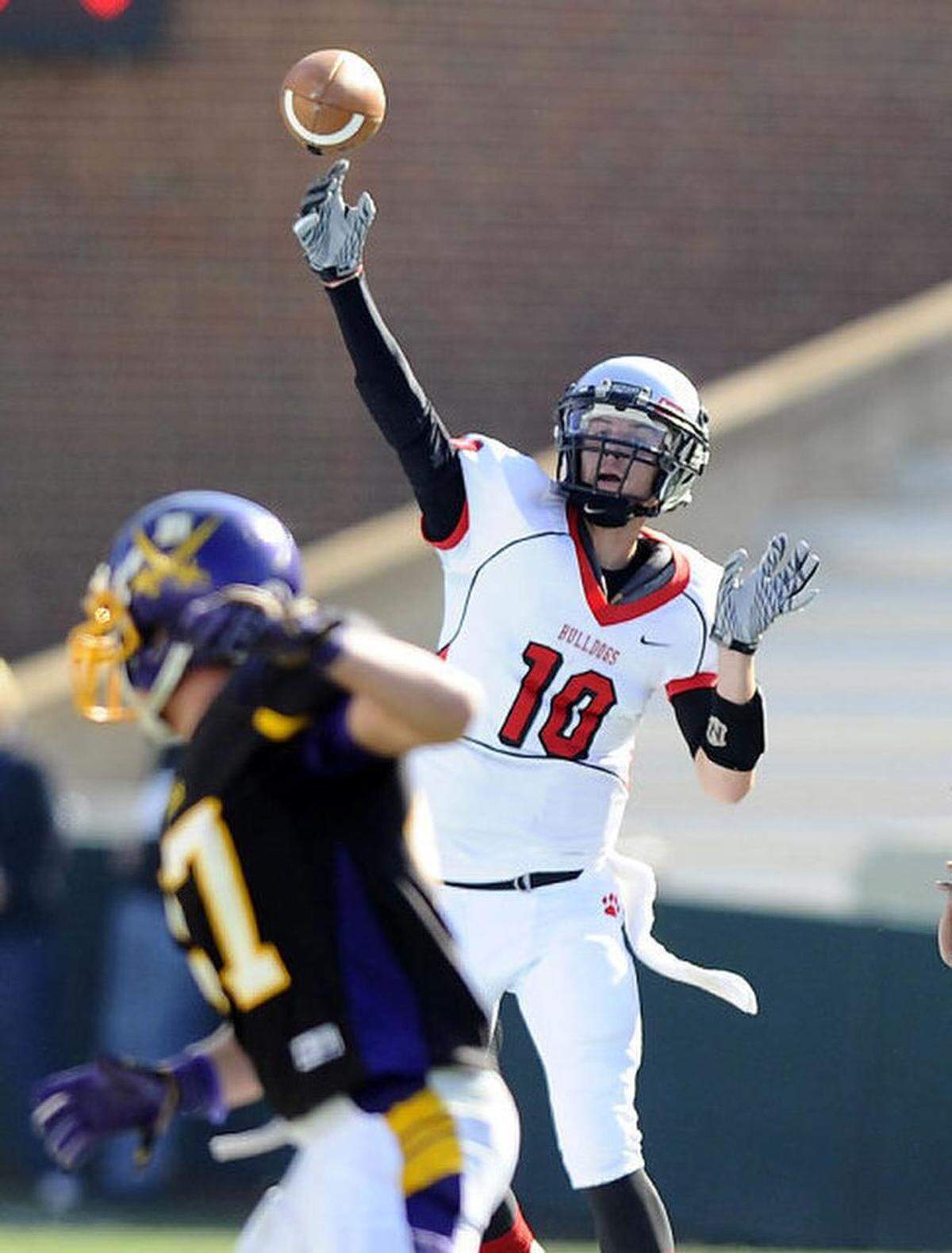 In the 2012 N.C. 4AA state final, Butler’s Riley Ferguson (10) throws downfield against Jack Britt defenders in a 56-28 win.