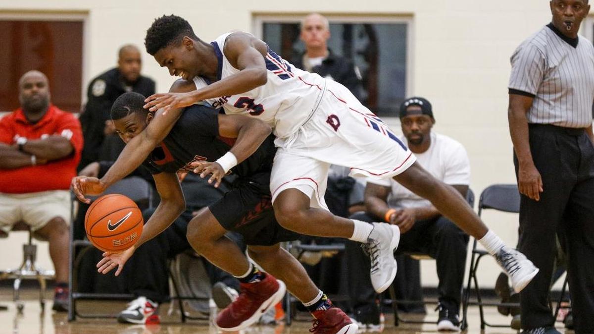 J.M. Robinson guard Lavar Batts Jr. and Providence Day guard Trey Wertz battle for a loose ball in high school basketball action at the Charlotte Hoops Challenge in Charlotte, N.C., Saturday, Nov. 26, 2016. (Nell Redmond photo)