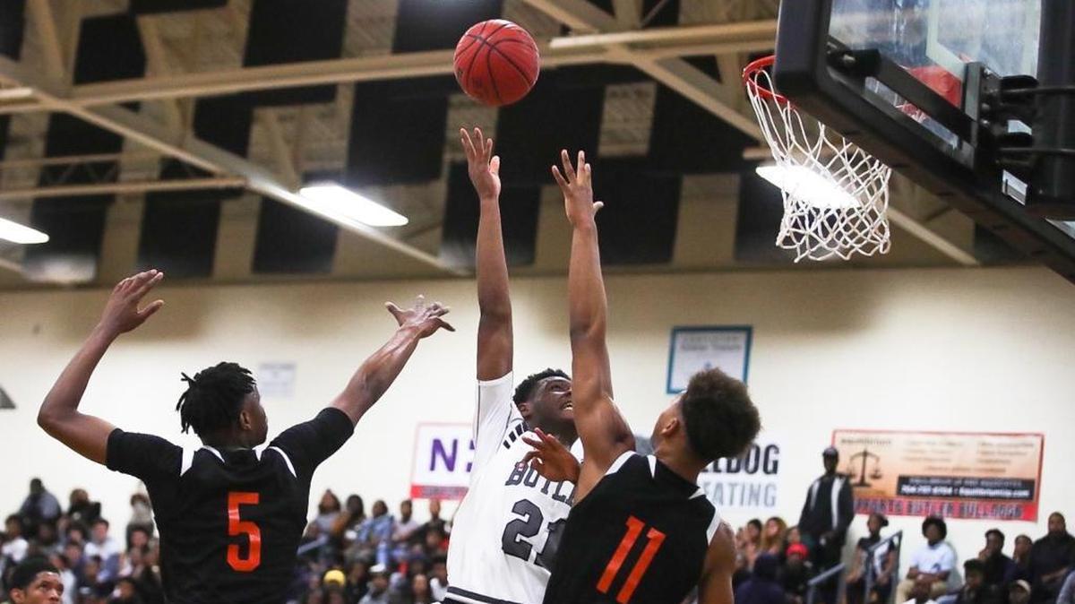 Butler's Rajaun Connor (21) completes the hook shot for a basket during Tuesday's matchup with Rocky River.