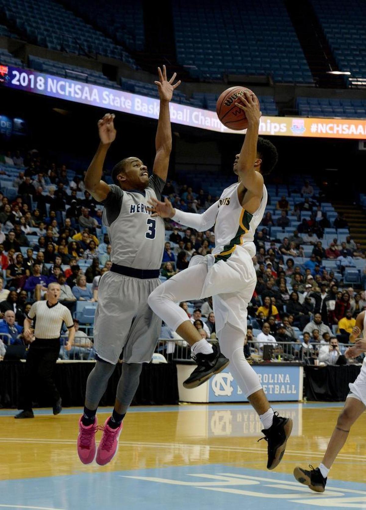 Independence # 4 Raja Milton shoots against Heritage # 3 Dyson Pender during Saturday evening's NCHSAA state basketball championship 4A game between Independence and Wake Forest Heritage at the Smith Center in Chapel Hill.