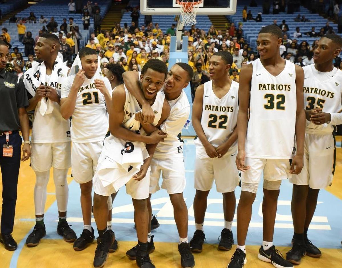 Independence players celebrate winning the state championship over Heritage after Saturday evening's NCHSAA state basketball championship 4A game between Independence and Wake Forest Heritage at the Smith Center in Chapel Hill.