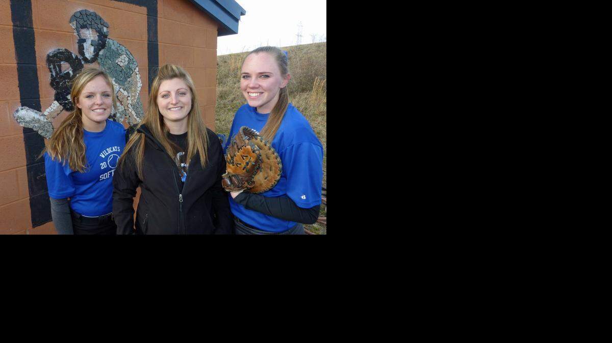 
Junior Kasey Moffett, left, and senior Jamie Pisel, right, flank first-year Lake Norman High softball coach Alex Lemings outside the Wildcats' dugout. Lake Norman returns 13 players from last year's team, which finished 17-9 and advanced to the fourth round of the NCHSAA 4A playoffs, the program's best showing in school history. 
