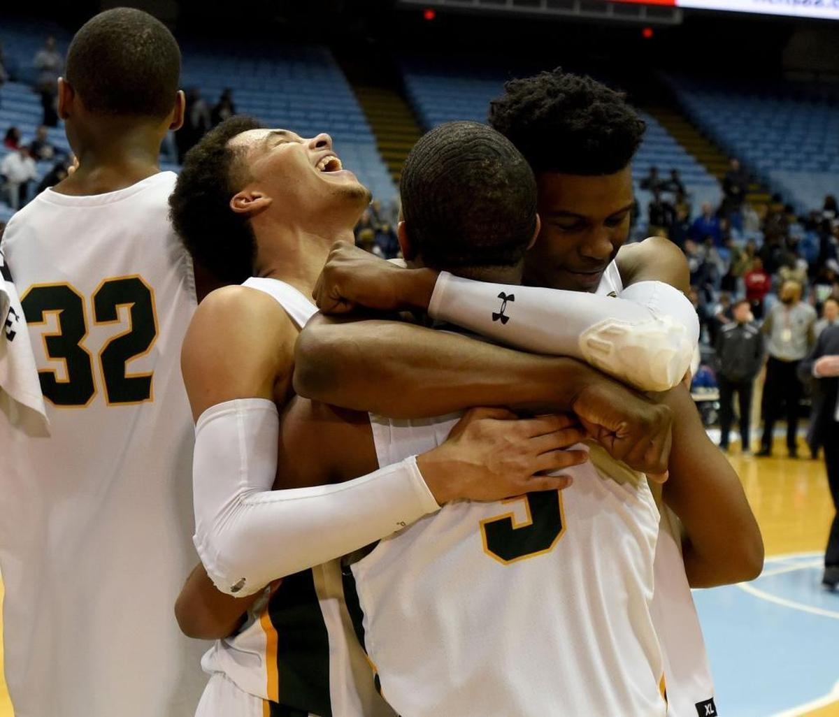 Independence players celebrate winning the state championship over Heritage after Saturday evening's NCHSAA state basketball championship 4A game between Independence and Wake Forest Heritage at the Smith Center in Chapel Hill.