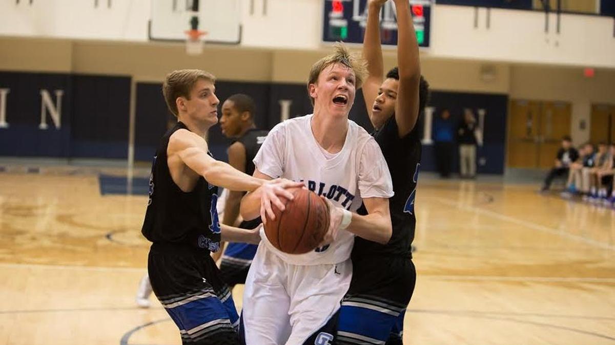 Charlotte Latin’s Parker Julian is fouled by two Charlotte Christian players in a win Friday night