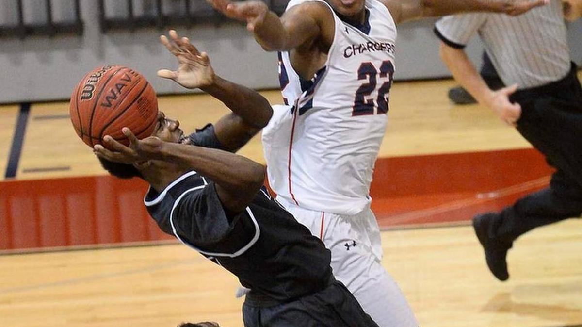 Providence Day’s Isaac Johnson blocks a shot attempt by a Norcoss (GA) player in the Chargers’ Hoodies House national bracket final win Wednesday