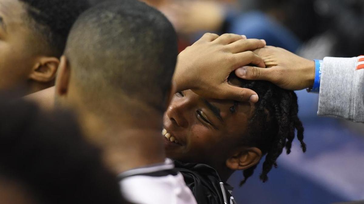 Butler’s Jordan McPhatter gets congratulations from fans as Butler players celebrate their win against Lincoln Charter in Friday night’s Hoodie’s House national tournament game at Providence Day.