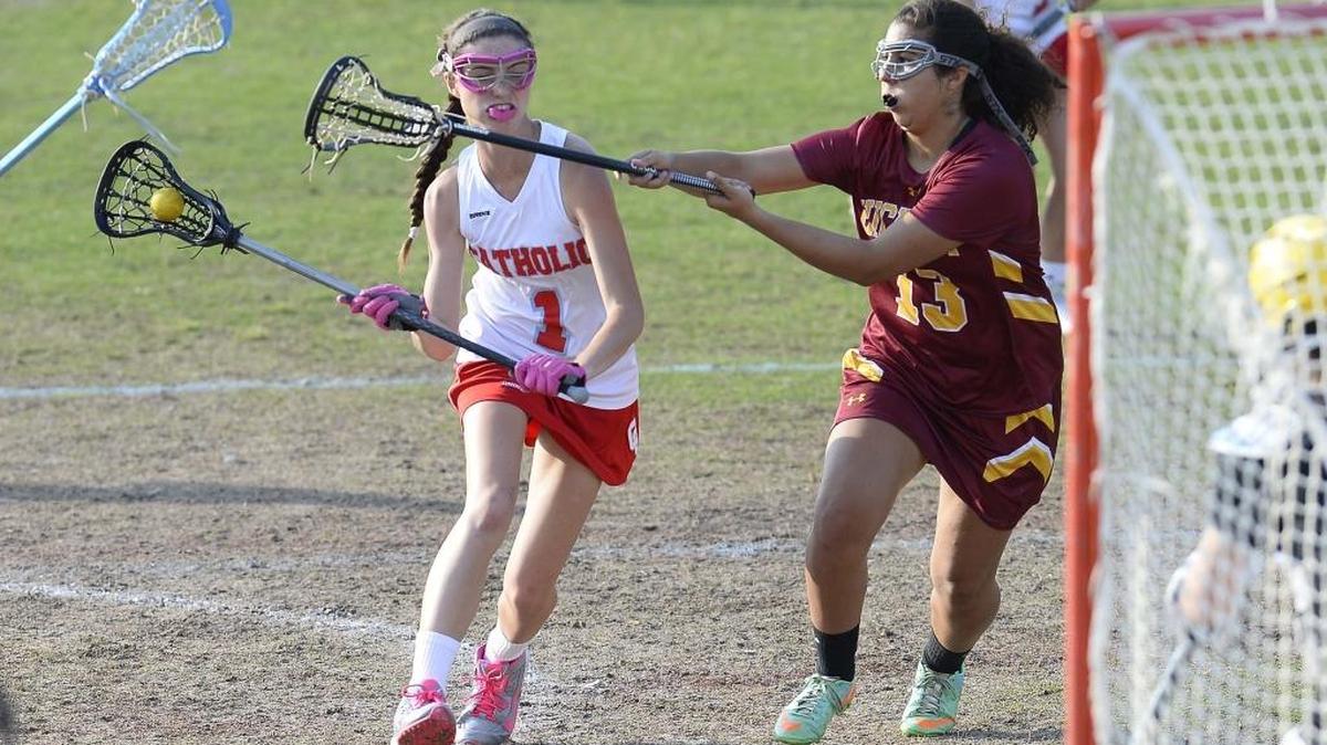 Charlotte Catholic’s Kaitlin Coleman, on left, scores against Hickory’s Victoria Eckard on right, during Tuesday’s third round playoff match on May 10, 2016 played at Charlotte Catholic. Charlotte Catholic defeated Hickory High 18-4.