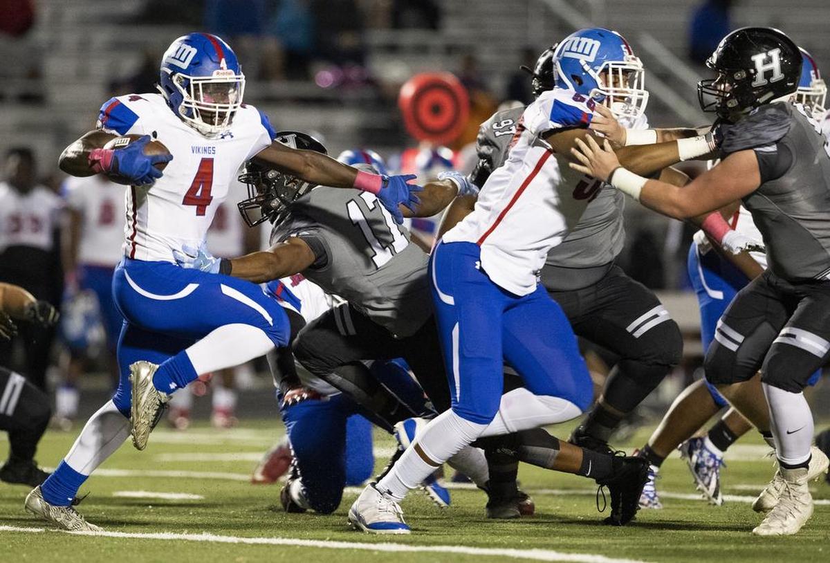North Mecklenburg running back Fabian Duncan, left, looks for running room against Hough’s defense Friday night. A senior, Duncan rushed 19 times for 151 yards, including a 70-yard touchdown. But the Vikings came up short, 42-27.