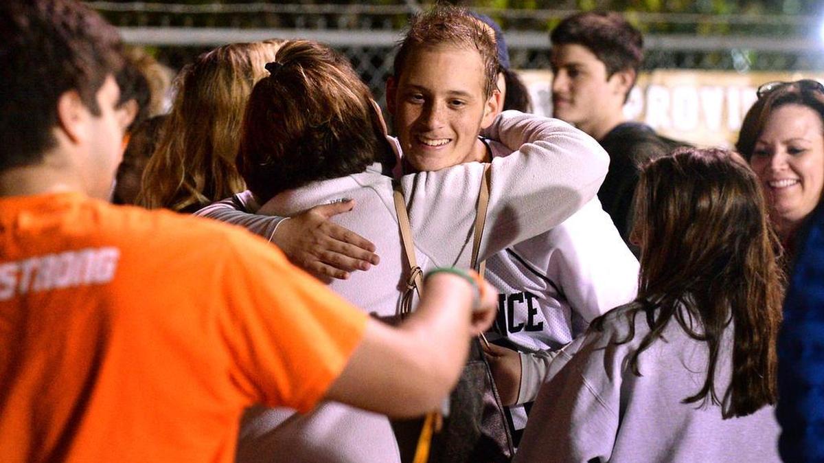 Providence senior lacrosse goalie Noah Hays (center) receives support from family and friends after Monday’s home game against Weddington. Hays, who skipped his junior year when he was diagnosed with cancer, had been cancer free for several months. Last Thursday, a scan showed the cancer has returned.