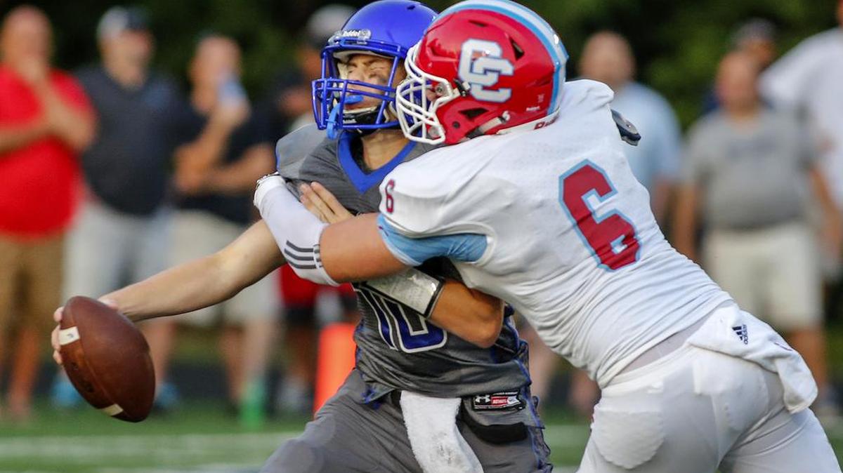 
Charlotte Catholic defensive end Connor Miller (6) sacks Charlotte Christian quarterback Jack Cherry in first half action at Charlotte Christian high school Friday, Aug. 21, 2015.
