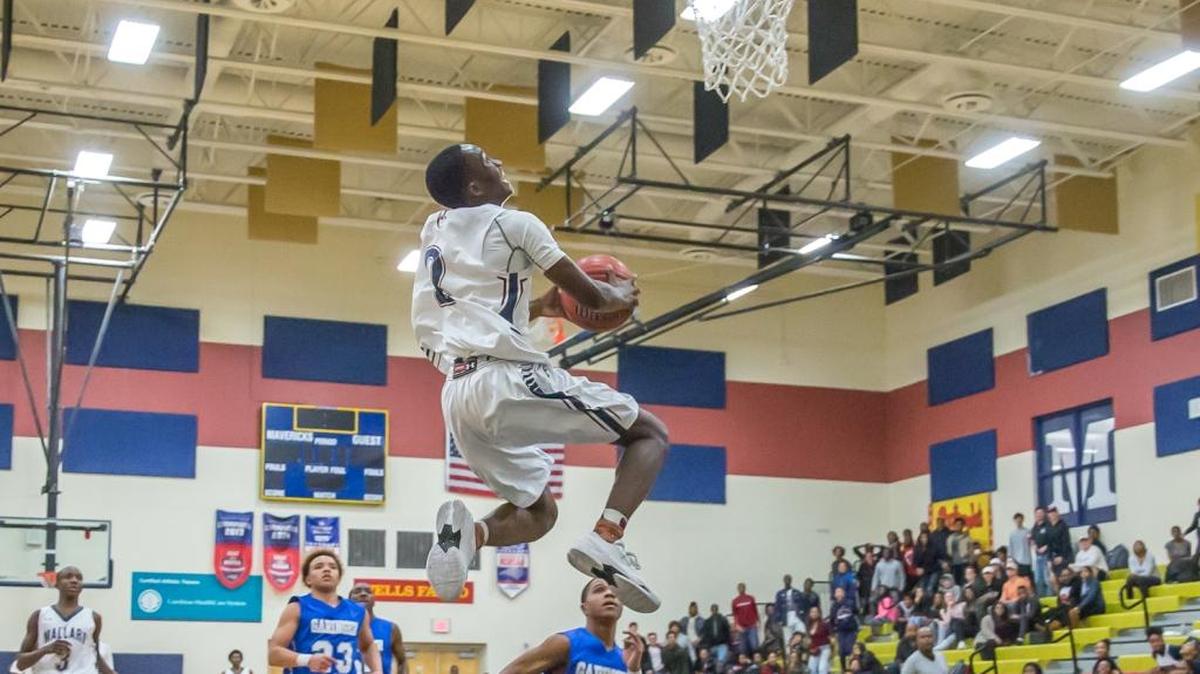 Junior Point Guard Jordan Campbell of Mallard Creek goes in for the dunk over the Garinger defender during late first half action. Mallard Creek defeated Garinger 83-60 at home on Tuesday Dec 20, 2016.