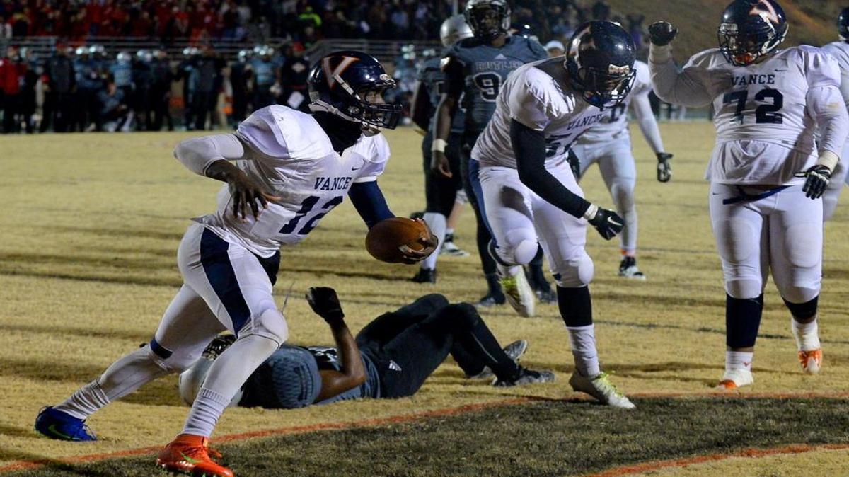 Vance Cougars quarterback Kingsley Ifedi scores the winning touchdown during overtime against the Butler Bulldogs at Butler High School on Friday. Vance defeated Butler 50-49.