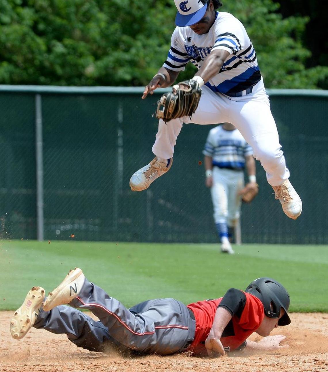 Charlotte Christian #4 Jonah Beamon tries to tag Wesleyan Christian Academy #13 Koty Proctor out at second base during Saturday's championship baseball game. Wesleyan Christian Academy defeated Charlotte Christian in the NCISAA 3A state championship baseball game at Charlotte Country Day Saturday afternoon.