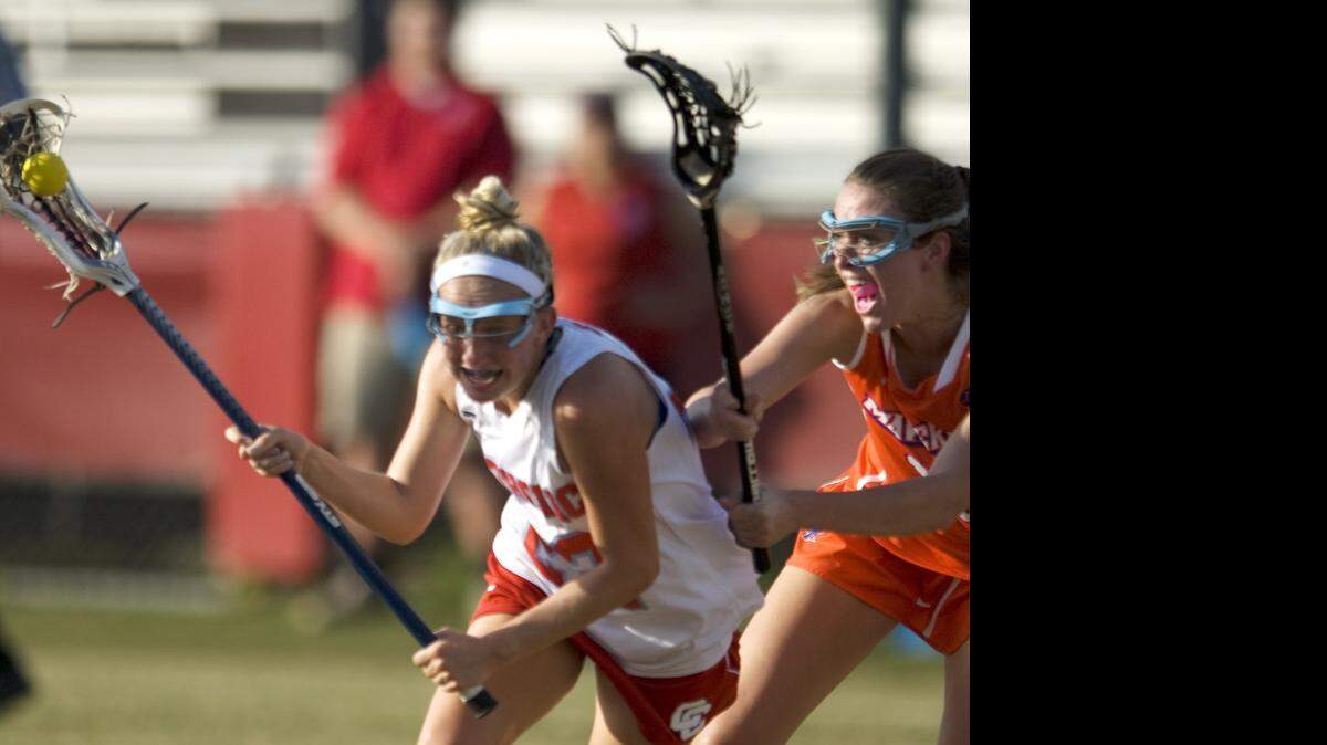 
Charlotte Catholic High's Katie Simpson, left, gets pushed by Marvin Ridge High's Chloe Wallace at Charlotte Catholic High School in Charlotte on Tuesday May 12, 2015.
