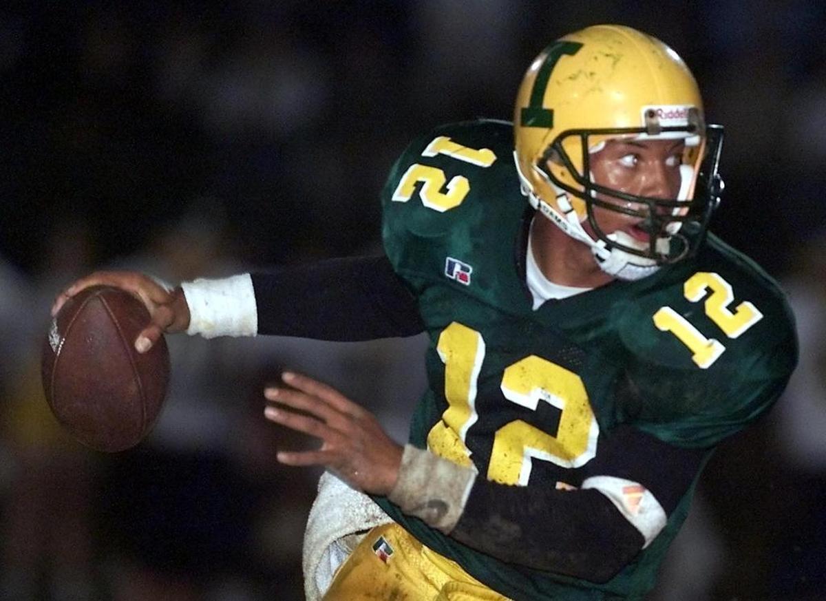 Patriots's QB Chris Leake looks for a receiver against N. Durham Friday night, Nov. 30, 2001 at Independance High. (Photo/Gerry Broome)