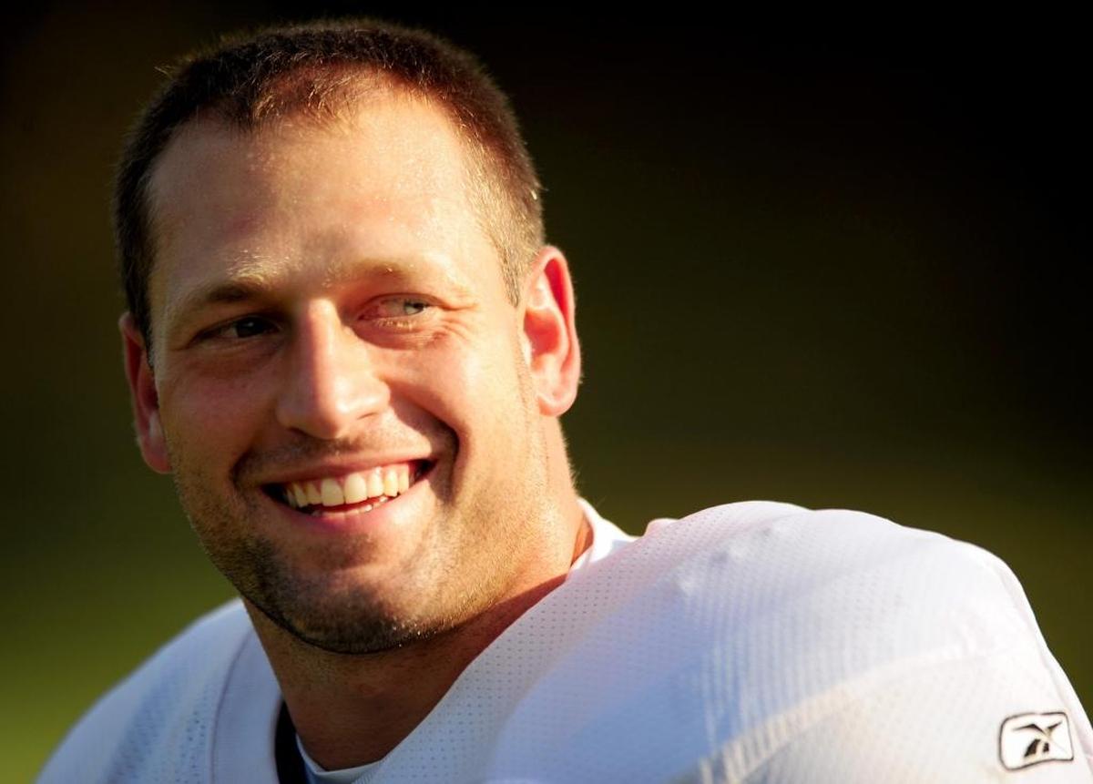 In 2009, Carolina Panthers fullback Brad Hoover greets a fan with a smile as he walked toward the practice fields at training camp in Spartanburg.